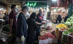 People buy food produce at a bazaar in Tehran, Iran.