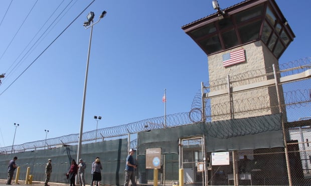 Poeple walk past a guard tower outside the fencing of Camp 5 at the US military’s prison in Guantánamo Bay, Cuba.