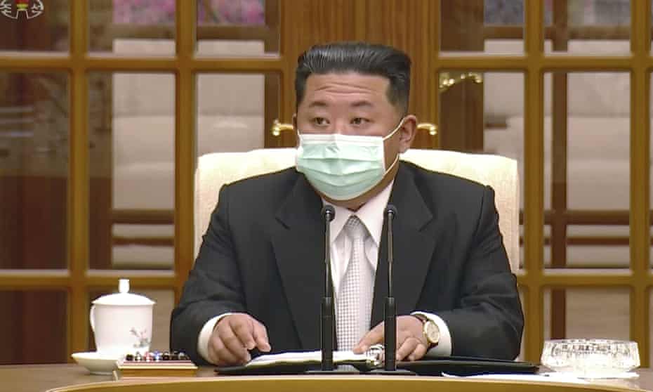 North Korean leader Kim Jong-un wears a face mask on state television during a meeting on 12 May acknowledging the country’s first case of Covid-19.