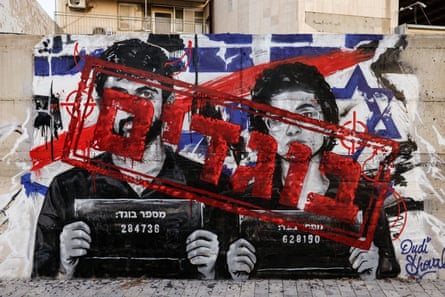 Graffiti depicting Abraham and Szor, with the word ‘traitors’ in Hebrew, in red across their images, on a wall in Ashdod.