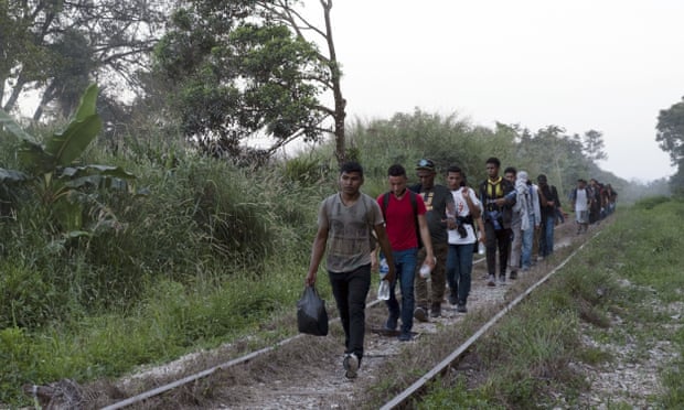 Central American migrants follow train tracks on their journey to the US border.