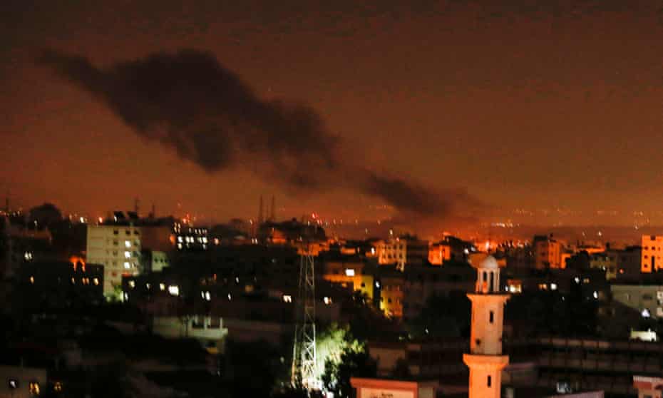 Smoke and flames rise from Gaza City after the Israeli air strikes on 26 December.