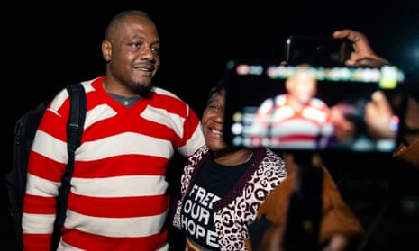 Zimbabwean journalist Hopewell Chin'ono is embraced by a supporter following his release on bail from Chikurubi in Harare, on 2 September 2020