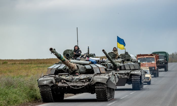 Ukrainian servicemen travel in a convoy of tanks towards the frontlines in Kharkiv on Saturday