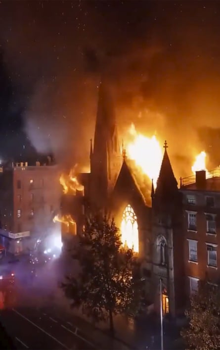Flames engulf the church, before dawn.