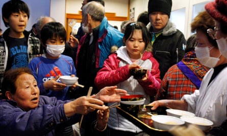 People from the area around the Fukushima plant receive a meal at an evacuation centre in 2011.