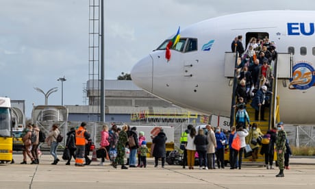 Ukrainian refugees exit a Euroatlantic jet