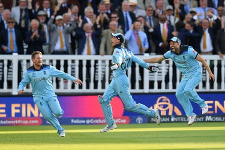 Mark Wood (right) and Liam Dawson rush to congratulate Jos Buttler on the decisive run-out in the 2019 World Cup final, watched by MCC members.