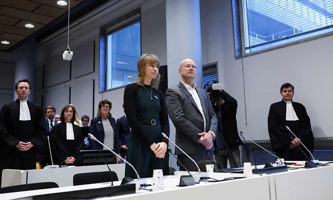 Winnie Oussoren and Donald Pols stand in court