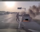 Footage shows Texas police officer rescuing man from burning car – video