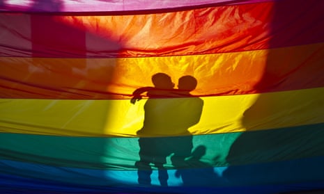 silhouette against a rainbow flag
