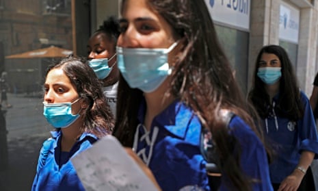 Young Israeli women wearing protective masks in the centre of Jerusalem