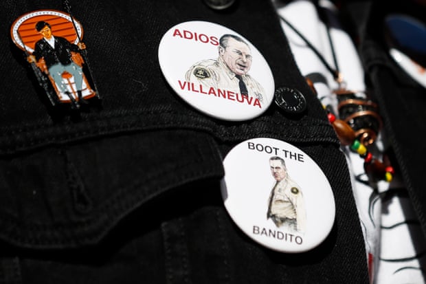 Pins on a person’s shirt bear likenesses of Alex Villanueva with the words ‘Adios Villanueva’ and ‘Boot the bandito’.