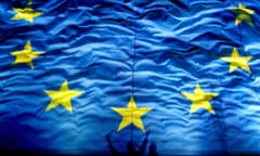 Jan. 1, 2012 file photo, cheering Romanians cast shadows on a giant European Union  flag