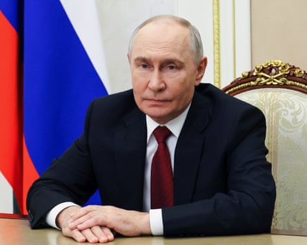 Vladimir Putin sitting at desk