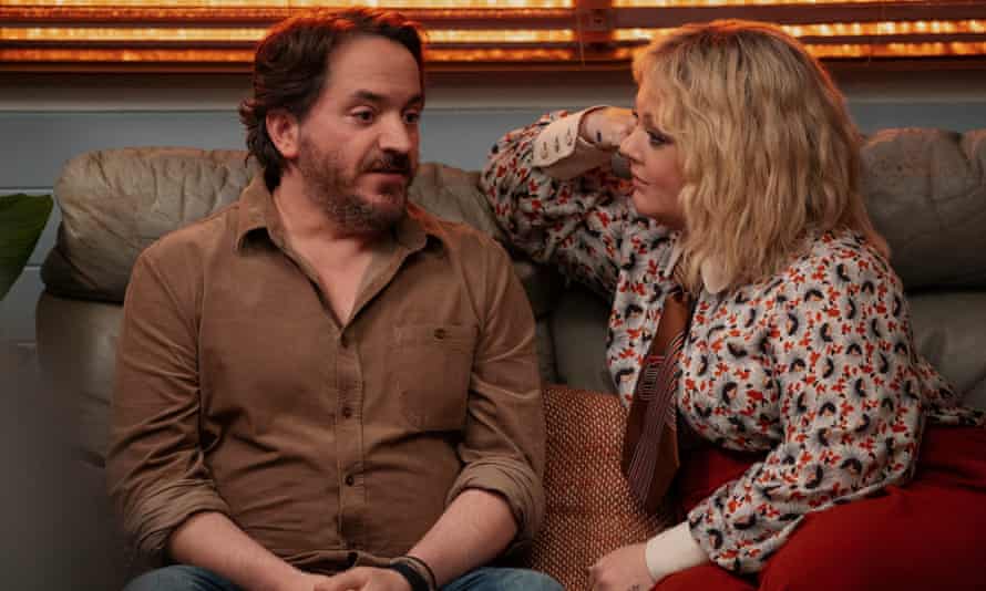 Ben Falcone as Clark Thompson and Melissa McCarthy as Amily Luck in God’s Favorite Idiot.