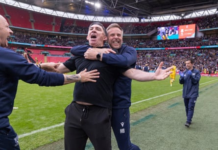 Southend’s manager, Kevin Maher, is embraced by Mark Bentley after the win is secured.