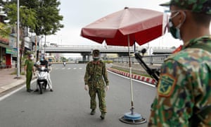 Vietnamese military personnel stand guard at a checkpoint in Ho Chi Minh City, after the government imposed a stricter lockdown to stop the spread of the Covid-19 coronavirus.