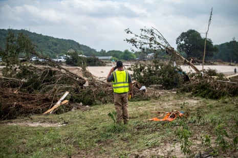 A volunteer rescue searcher speaks on the phone after deadly flooding in Kerr County.