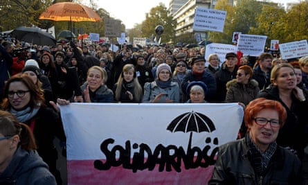 People protest in front of parliament in Warsaw