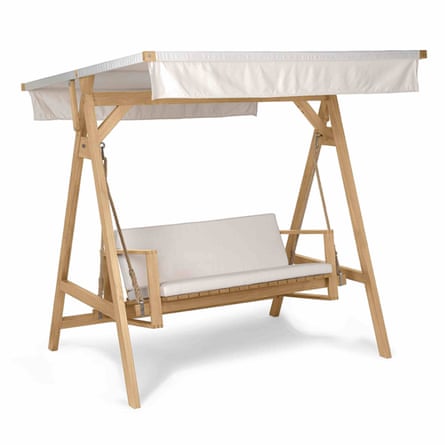 A wooden A-frame swing seat. The cushions on the bench are cream. And there is a tilted canvas canopy at the top of the frame.