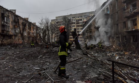 Firefighters work at the site of an apartment block destroyed by Russian strikes in Vyshhorod, near Kyiv