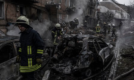 Firefighters at the scene of a Russian missile strike in Kyiv.