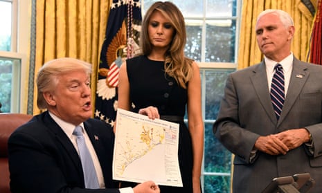 Trump displays a map of the Texas Gulf Coast to the press as he discusses tropical storm Harvey relief efforts.
