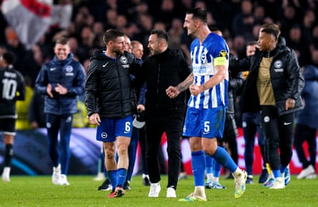 Roberto De Zerbi, the Brighton manager, speaks to James Milner after their Europa League victory over Ajax at the Amex