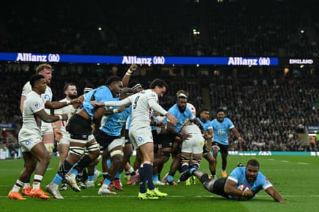 Fiji's hooker Tevita Ikanivere dives over the line to score their first try.