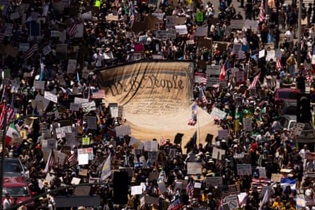 a large group holds a giant banner