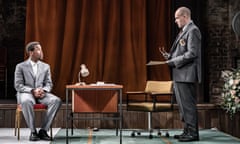 Micheal Ward and Jonny Lee Miller on a stage set with a desk and a chair.