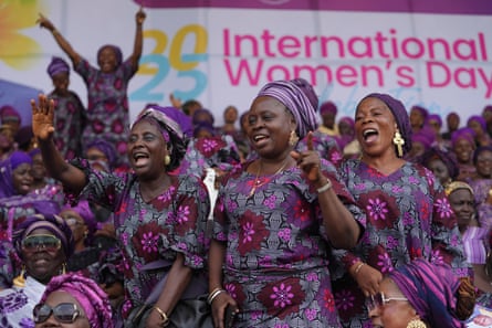 Celebrations and protests in the US and around the world mark International Women’s Day Women in purple smiling