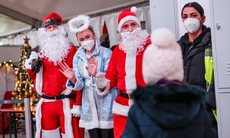 Epiphany Singers Perform For Ukrainian Refugees At Tegel CenterBERLIN, GERMANY - JANUARY 07: Volunteers in Santa costumes welcome refugees from Ukraine to an Epiphany event at the Tegel refugees registration center and temporary shelter on January 7, 2023 in Berlin, Germany. Over 100,000 refugees from Ukraine have sought shelter in Berlin as Russia's war in Ukraine continues to rage nearly one year on. (Photo by Omer Messinger/Getty Images)