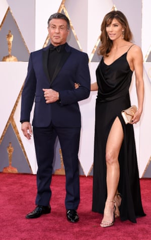 Sylvester Stallone goes for a flattering black and blue tux while and Jennifer Flavin shows what a combination of gym hours, Saint Laurent and the Left Leg legacy looks like