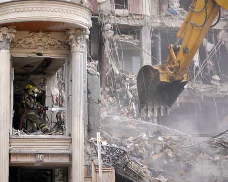 Rescue workers and first responders work at a residential building hit in a US-Israeli strike in Tehran.