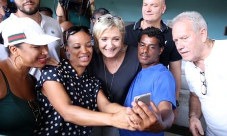 The National Front leader, Marine Le Pen, centre, poses for a selfe during a campaign visit to the Indian Ocean island of La Reunion.