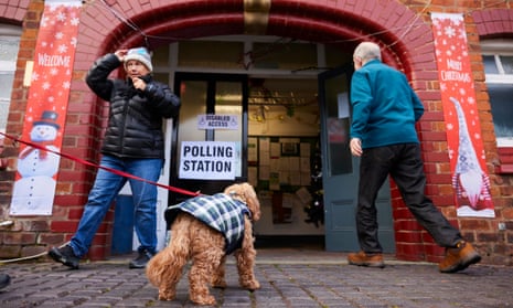 Early voters and a dog at a polling station in Saughall in the City of Chester byelection