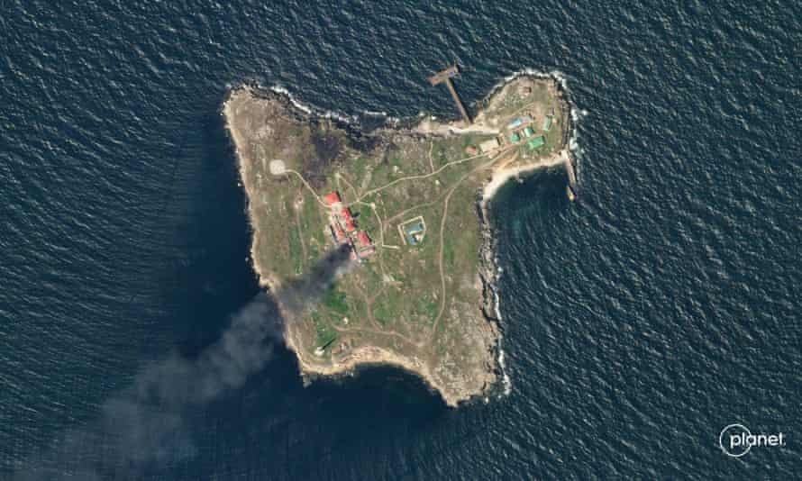 A outer presumption shows fume rising implicit Snake Island, Ukraine.