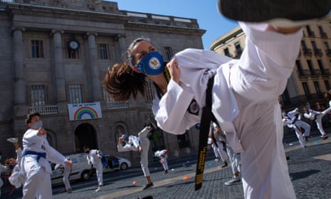 Dozens of people practice martial arts in front of the regional government headquarters in Barcelona, Spain, as a protest against the closure of gyms and martial arts centres in the region due to coronavirus