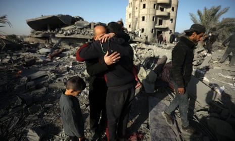 Palestinians mourn the death of relatives amid the rubble after an Israeli strike on a house in Rafah