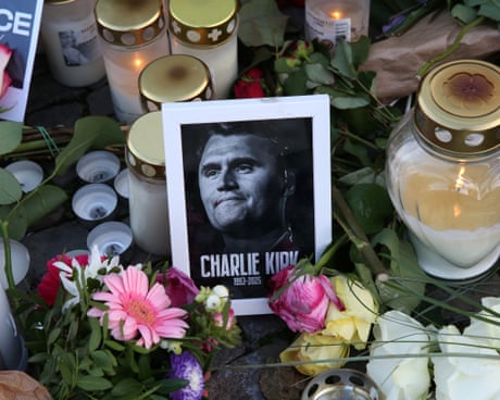 Flowers and candles surround a portrait of Charlie Kirk