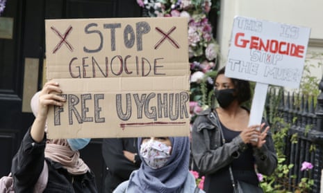 Protesters with a sign saying ‘Stop genocide: free Uyghur’ outside the Chinese embassy in London