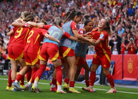 Claudia Pina is mobbed by her teammates after scoring Spain’s winner.