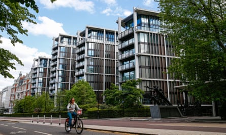A cyclist passes the One Hyde Park residential and retail complex in Knightsbridge, London.