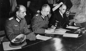Gen Alfred Jodl, centre, signing the unconditional surrender of all armed German forces in Reims on 7 May 1945.