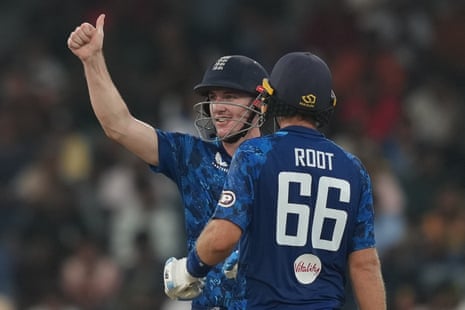 England's captain Harry Brook celebrates his century as Joe Root watches during the third ODI cricket match between England and Sri Lanka