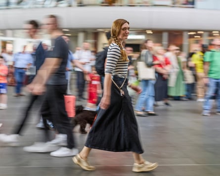 Nicola Davis striding through King’s Cross train station