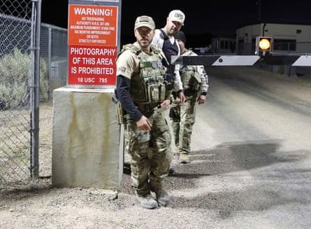 Law enforcement monitor a gate to Area 51.