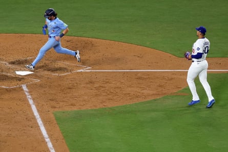 Addison Barger of the Blue Jays advances home to score a run on a wild pitch by Edgardo Henriquez during the seventh inning.